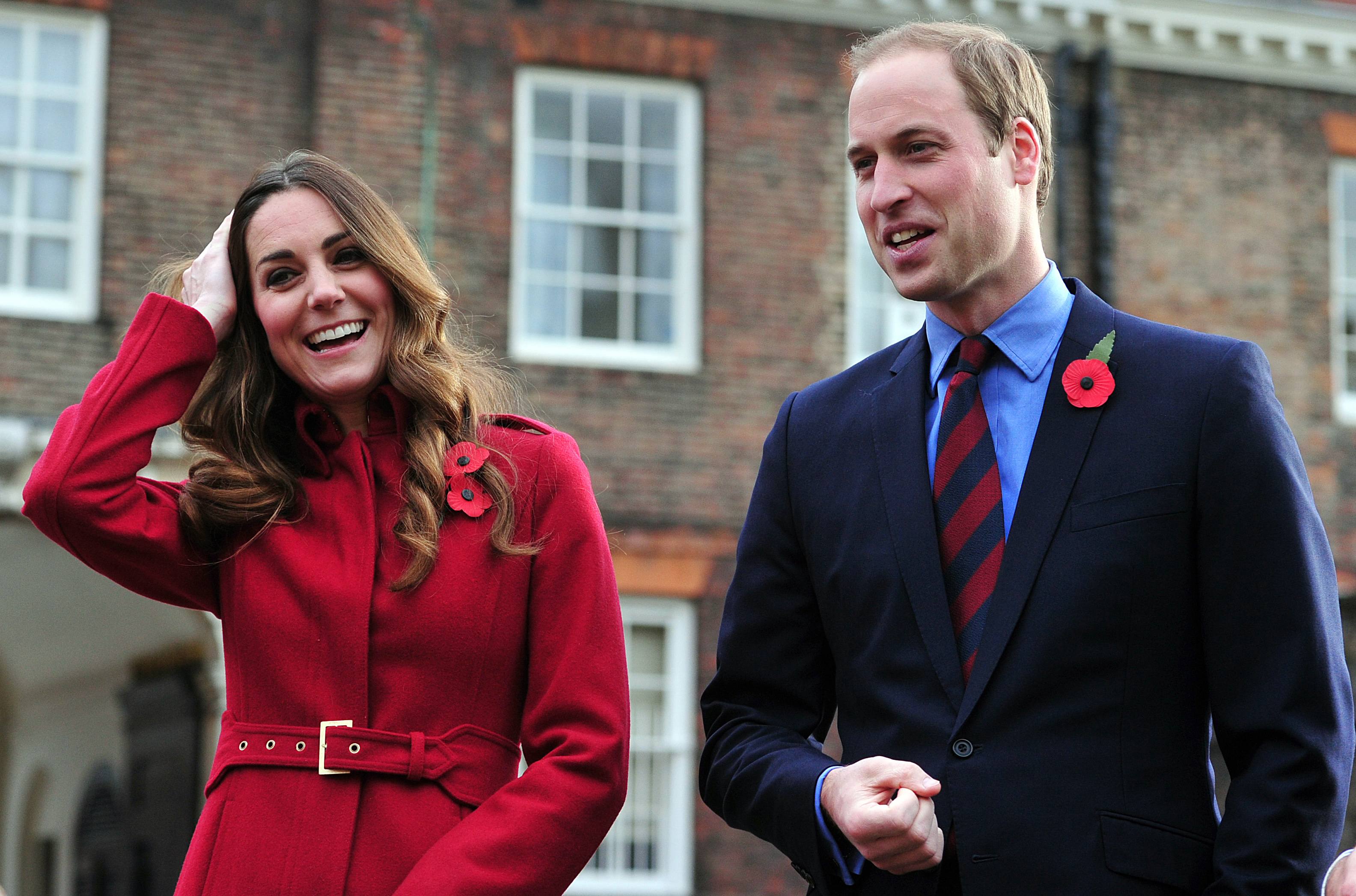 Britain's Prince William and his wife Catherine, Duchess of Cambridge, arrive to meet volunteers and workers during a Royal British Legion Poppy Day event at Kensington Palace in London